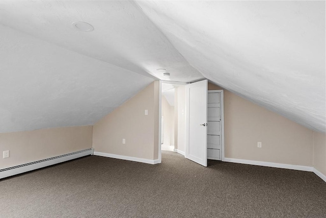 additional living space featuring carpet, a baseboard heating unit, baseboards, and vaulted ceiling