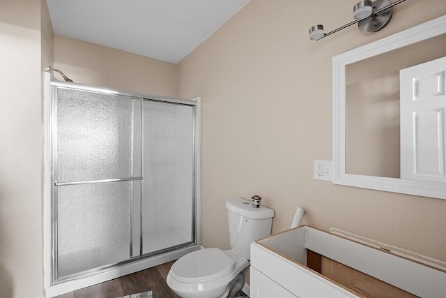 full bathroom with vanity, a shower stall, toilet, and wood finished floors