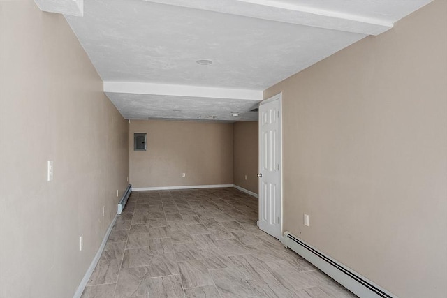 below grade area featuring a baseboard heating unit, baseboards, and baseboard heating