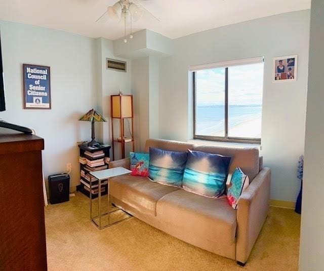 living room with light carpet and ceiling fan