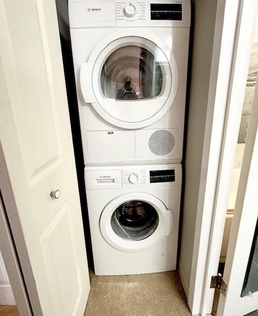 laundry room featuring stacked washer / dryer