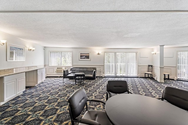 131 Coolidge Ave Unit 621, Watertown, MA 02472 - living room with carpet, a decorative wall, plenty of natural light, a textured ceiling, and a wainscoted wall