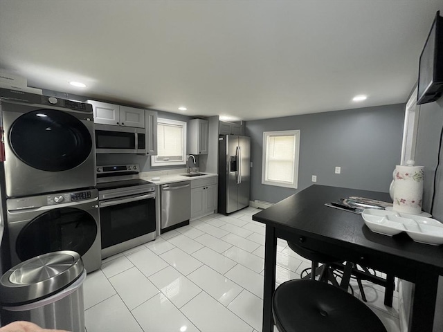 27 Overlook Rd, Holbrook, MA 02343 - kitchen featuring stainless steel appliances, stacked washer / dryer, a baseboard radiator, light countertops, and a sink