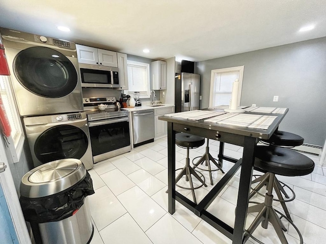 27 Overlook Rd, Holbrook, MA 02343 - kitchen with stainless steel appliances, stacked washer / drying machine, light countertops, a sink, and recessed lighting