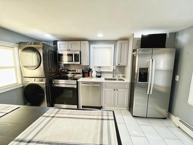 27 Overlook Rd, Holbrook, MA 02343 - kitchen with stainless steel appliances, stacked washing machine and dryer, a sink, baseboard heating, and light tile patterned flooring