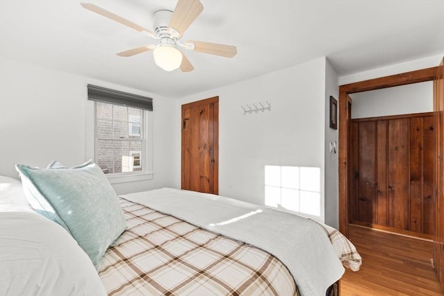 bedroom featuring wood-type flooring and ceiling fan