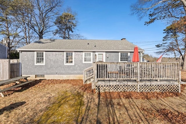 rear view of house with a yard and a deck