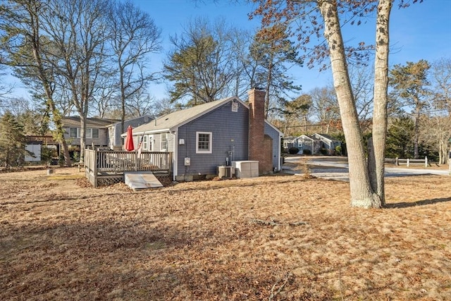 view of side of home featuring a wooden deck and cooling unit