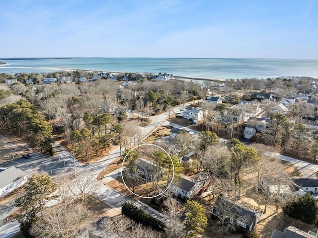 birds eye view of property with a water view and a beach view