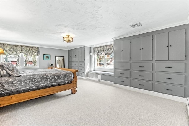 carpeted bedroom featuring ornamental molding and visible vents