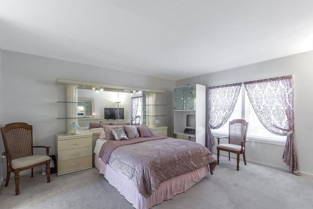 bedroom featuring light carpet