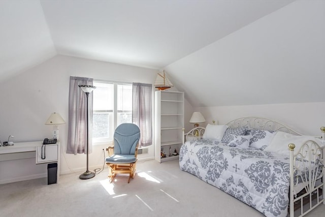 bedroom featuring lofted ceiling and carpet