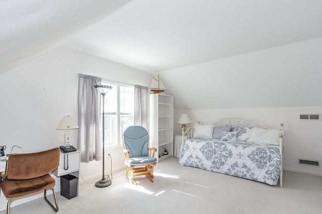 bedroom with lofted ceiling, visible vents, and carpet floors