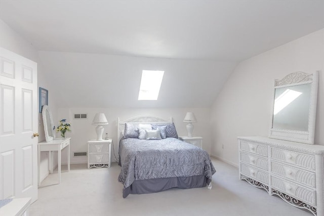 bedroom with carpet floors, visible vents, and lofted ceiling with skylight