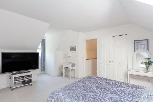 bedroom featuring lofted ceiling, carpet flooring, and baseboards