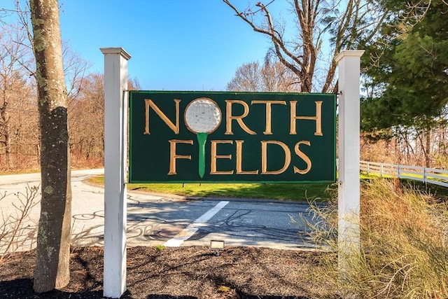 community / neighborhood sign featuring fence