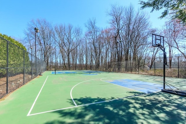 view of basketball court featuring community basketball court and fence