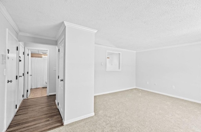 additional living space featuring a textured ceiling and dark colored carpet