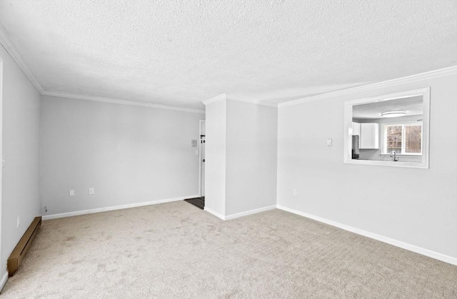 carpeted spare room featuring sink, a textured ceiling, and ornamental molding