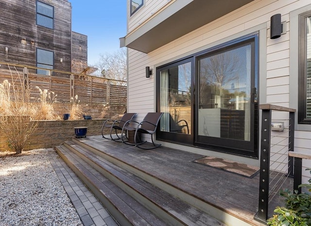 wooden terrace featuring fence