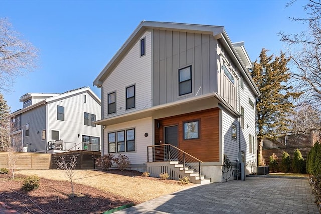 view of front of property with board and batten siding and fence