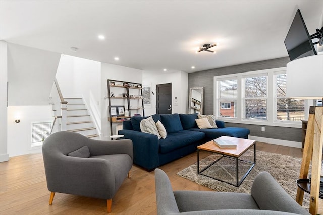 living area with stairway, recessed lighting, wood finished floors, and visible vents