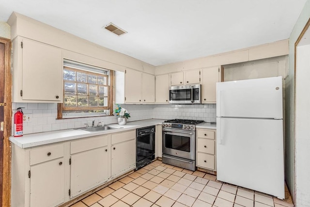 36 Fontaine St, Marlborough, MA 01752 - kitchen featuring stainless steel appliances, tasteful backsplash, light countertops, and light tile patterned floors
