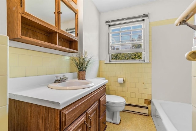 36 Fontaine St, Marlborough, MA 01752 - bathroom featuring baseboard heating, tile walls, vanity, a tub, and wainscoting