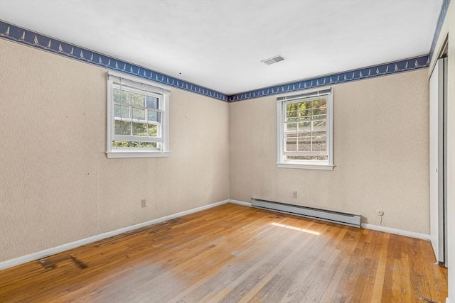 36 Fontaine St, Marlborough, MA 01752 - spare room featuring baseboard heating, hardwood / wood-style floors, and plenty of natural light