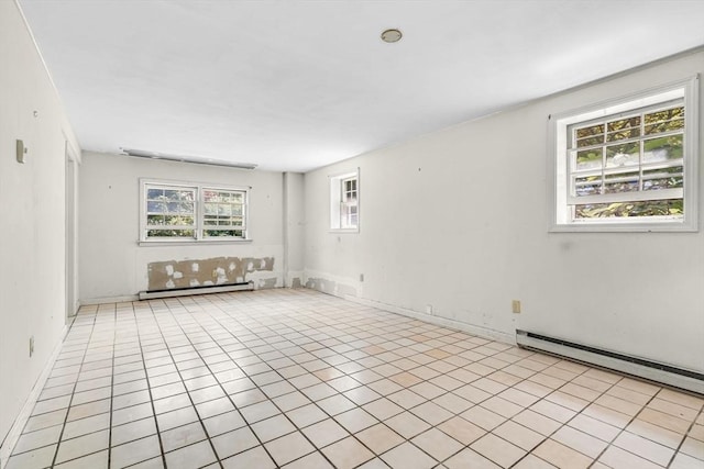 36 Fontaine St, Marlborough, MA 01752 - empty room featuring a baseboard heating unit, a baseboard radiator, and light tile patterned floors
