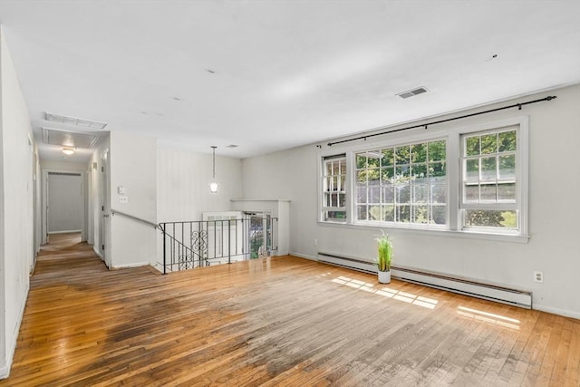 36 Fontaine St, Marlborough, MA 01752 - unfurnished room with baseboard heating, attic access, and hardwood / wood-style flooring