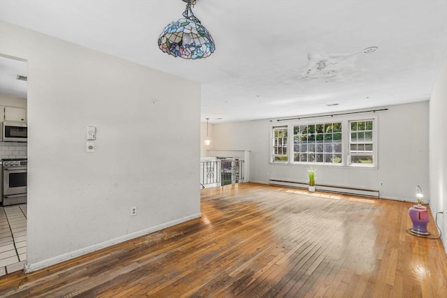 36 Fontaine St, Marlborough, MA 01752 - unfurnished living room with a baseboard radiator and wood-type flooring