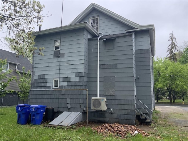 back of property with fence and ac unit