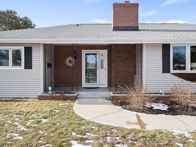 view of exterior entry with covered porch