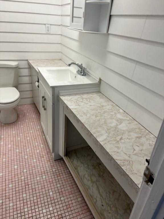 57 Broadlawn Park Unit 24, Boston, MA 02467 - half bath with vanity, toilet, and tile patterned floors