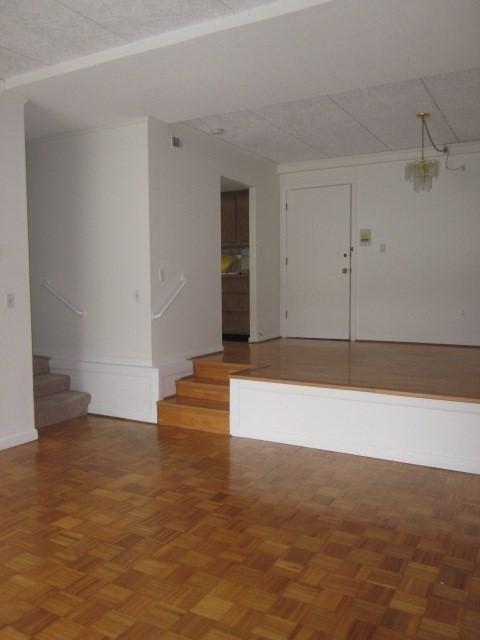 57 Broadlawn Park Unit 24, Boston, MA 02467 - empty room featuring stairway and baseboards