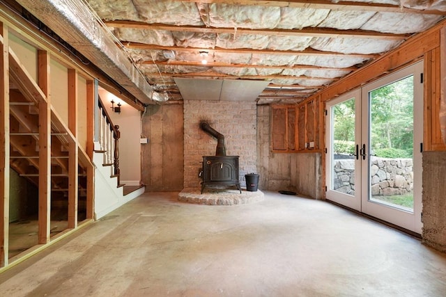 50 Elm St, Plympton, MA 02367 - unfurnished living room with unfinished concrete floors, a wood stove, french doors, and stairs
