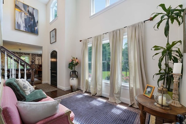50 Elm St, Plympton, MA 02367 - living room with healthy amount of natural light, wood finished floors, a towering ceiling, baseboards, and stairs