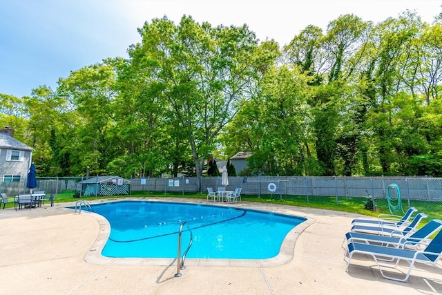 66 Captain Cook Ln Unit 66, Barnstable, MA 02632 - community pool featuring a patio area and view of wooded area