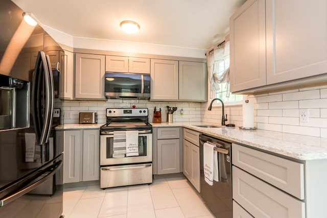 66 Captain Cook Ln Unit 66, Barnstable, MA 02632 - kitchen featuring appliances with stainless steel finishes, a sink, gray cabinetry, and backsplash