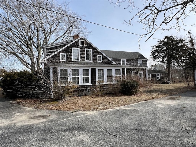 view of front facade featuring a chimney
