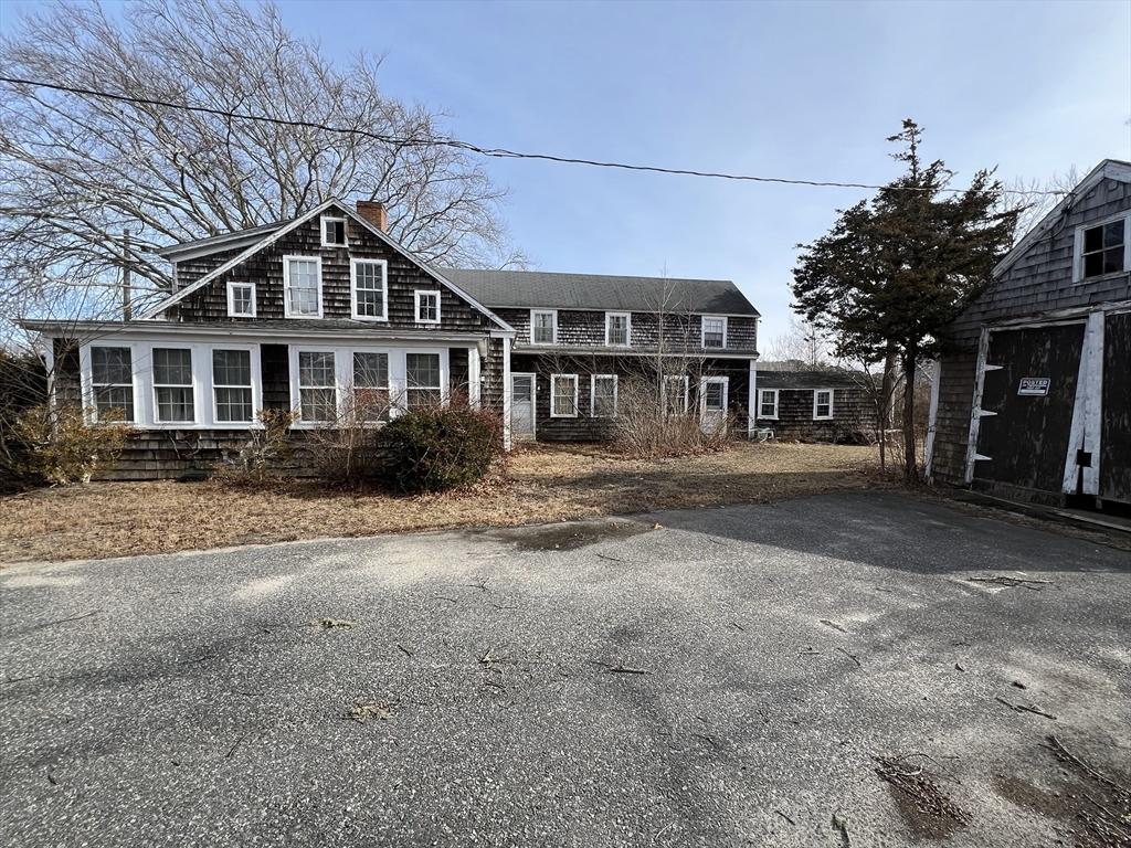 shingle-style home featuring a chimney