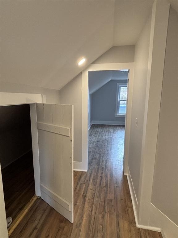 bonus room featuring baseboards, vaulted ceiling, and dark wood-style flooring