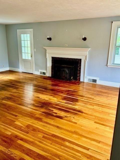 1 Ingalls Ter, Lynnfield, MA 01940 - unfurnished living room featuring wood finished floors and a fireplace
