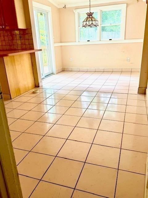1 Ingalls Ter, Lynnfield, MA 01940 - unfurnished dining area featuring healthy amount of natural light, light tile patterned floors, and a chandelier