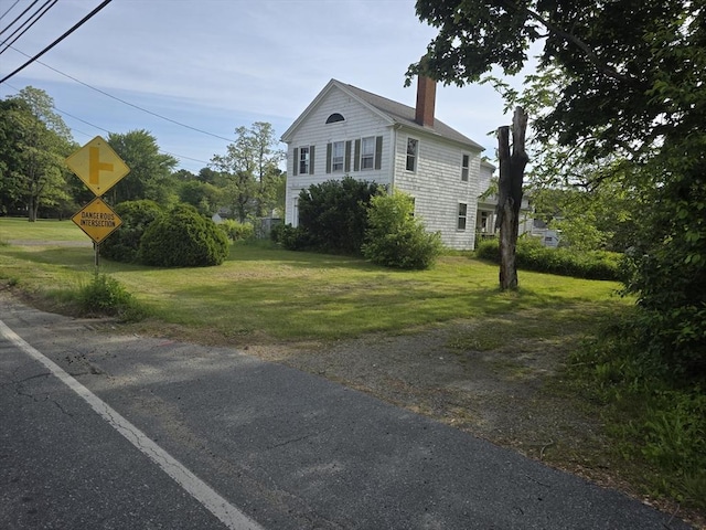 1164 Main St, Acushnet, MA 02743 - view of front facade featuring a chimney and a front yard