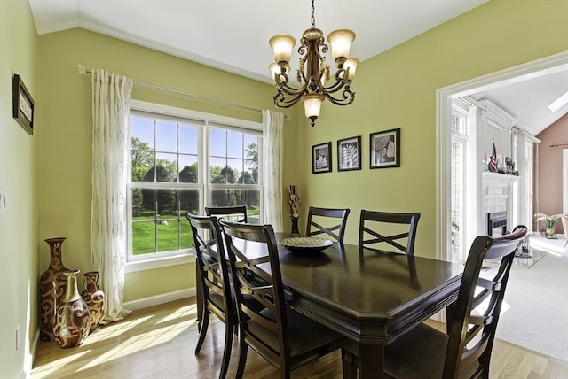 26 Waterville Ln, Shrewsbury, MA 01545 - dining room with lofted ceiling, a chandelier, plenty of natural light, wood finished floors, and a fireplace