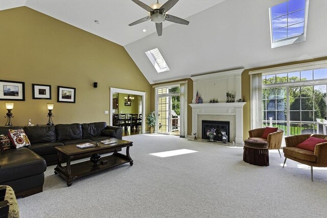26 Waterville Ln, Shrewsbury, MA 01545 - carpeted living area with high vaulted ceiling, a ceiling fan, a skylight, and a premium fireplace