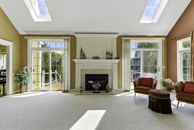 26 Waterville Ln, Shrewsbury, MA 01545 - carpeted living room featuring a skylight, vaulted ceiling, healthy amount of natural light, and a premium fireplace