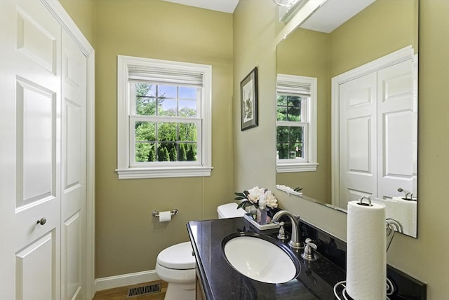 26 Waterville Ln, Shrewsbury, MA 01545 - bathroom with plenty of natural light, toilet, vanity, and baseboards